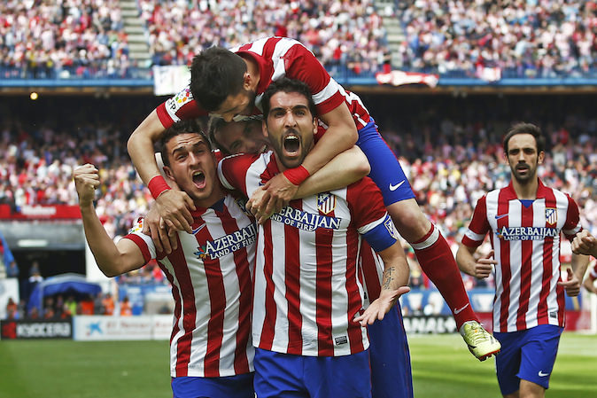 Atletico's Raul Garcia, center right, celebrates his goal with teammates during a Spanish La Liga soccer match between Atletico Madrid and Villarreal at the Vicente Calderon stadium in Madrid, Spain, Saturday, April 5, 2014. (AP Photo/Andres Kudacki)